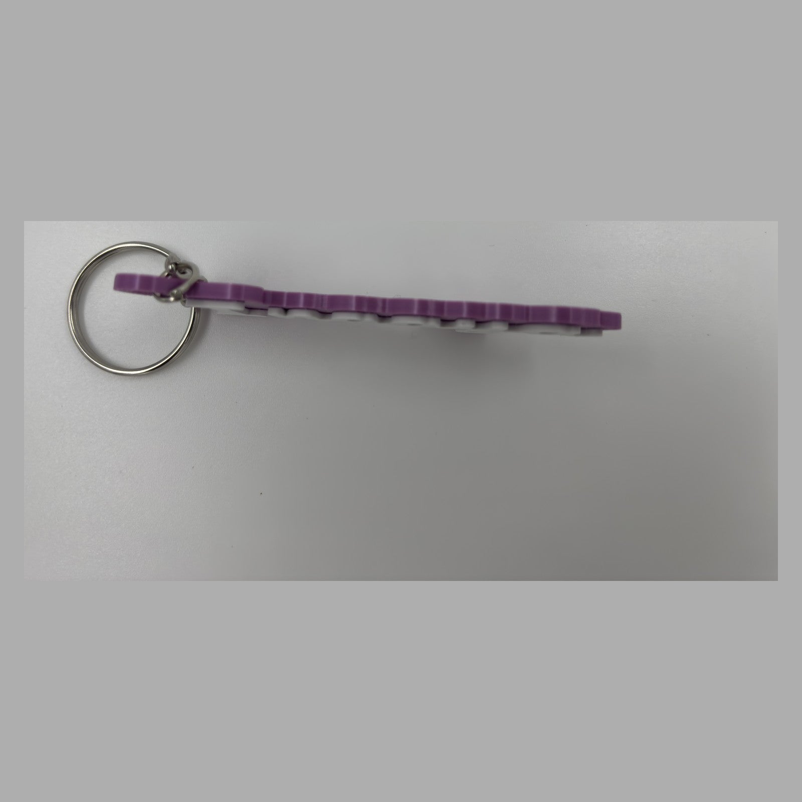 Cursive name keychain — photograph of the printed piece