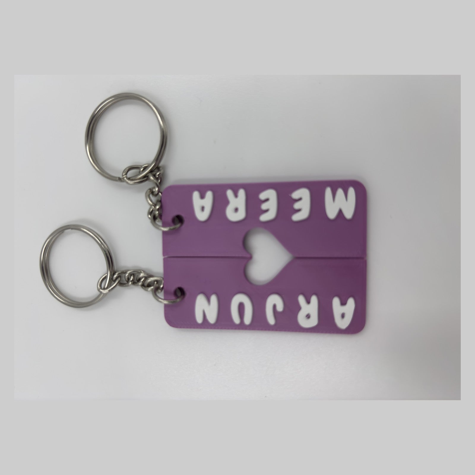 Pair of interlocking heart name keychains — photograph of the printed piece