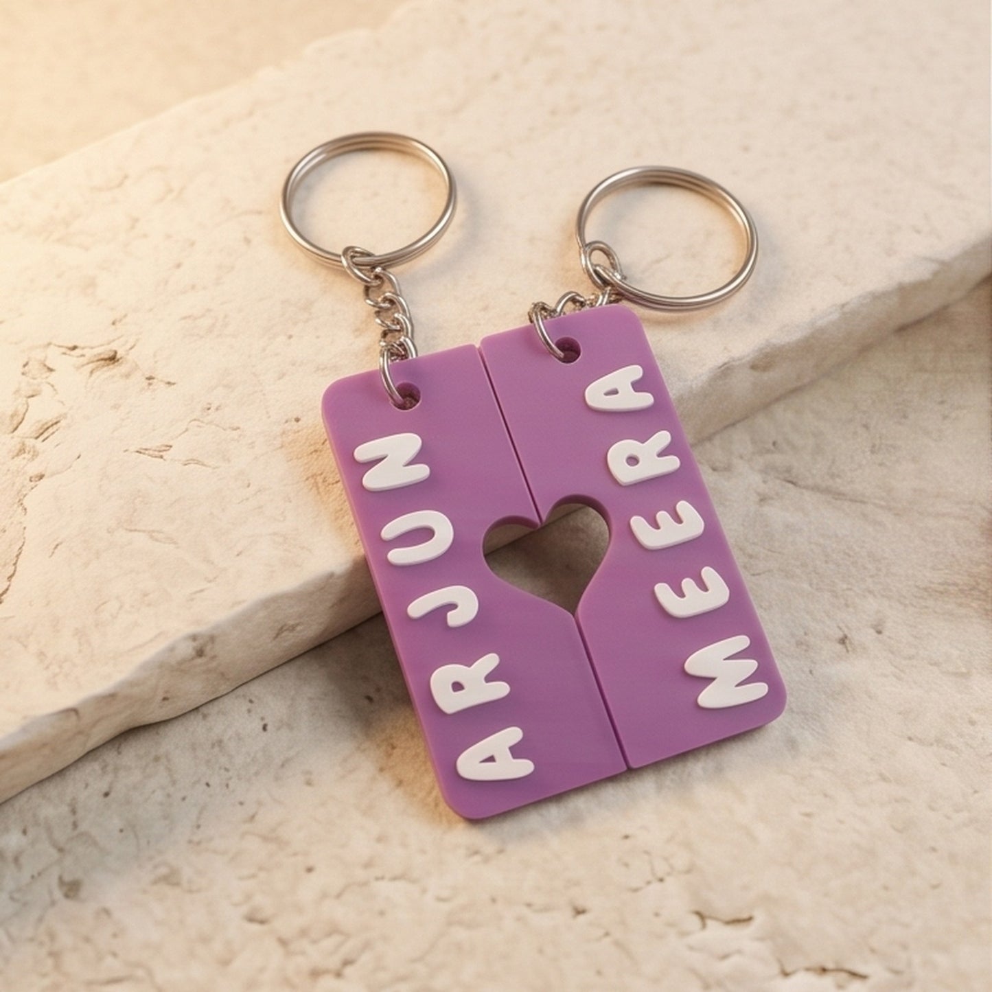 Pair of interlocking heart name keychains — styled view 1