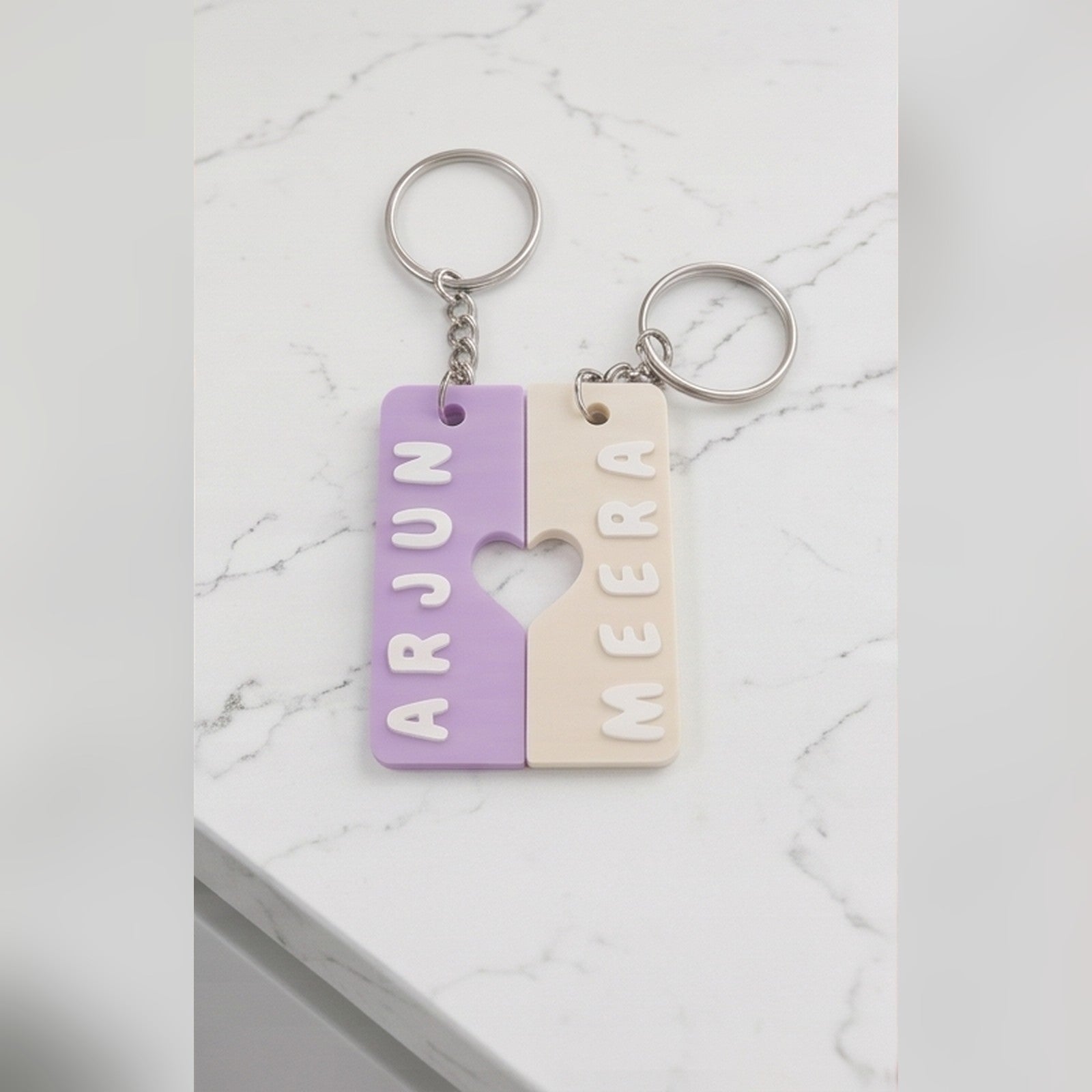 Pair of interlocking heart name keychains — styled view 2
