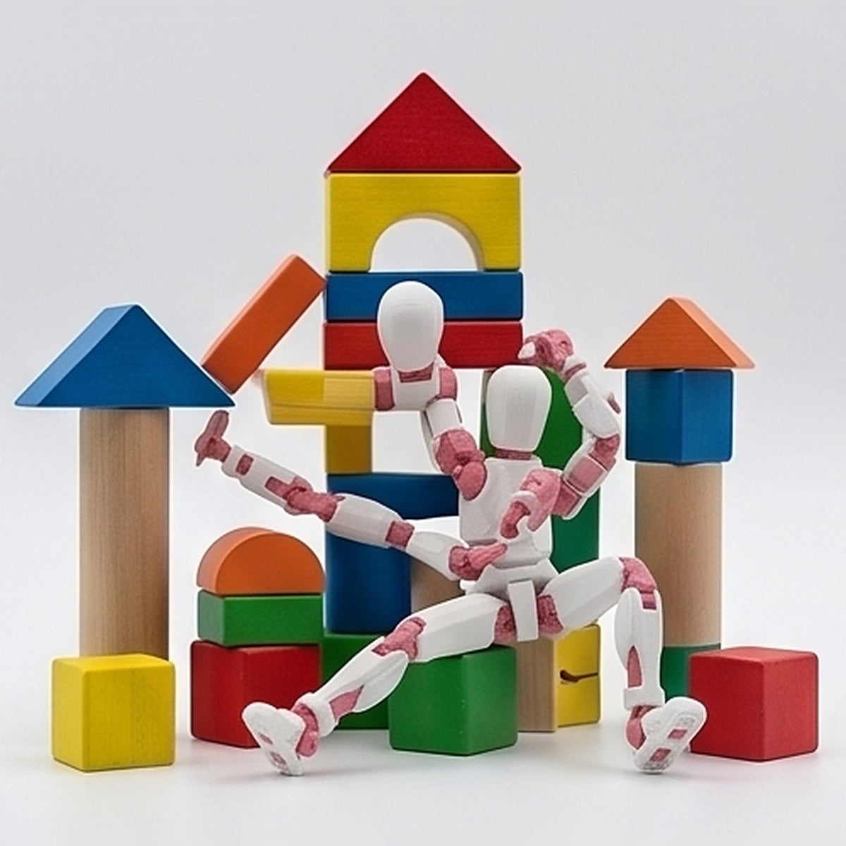 Two flexible figurines climbing a tower of wooden blocks