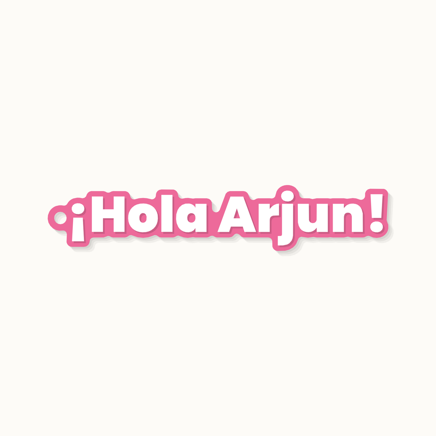 A keychain reading Hola Arjun in Spanish