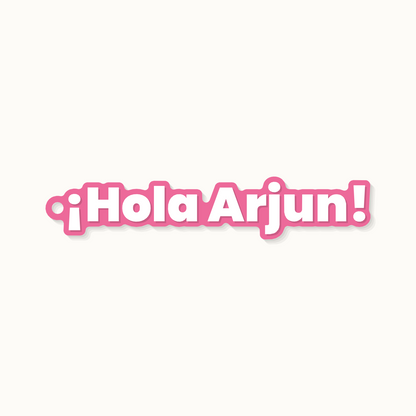 A keychain reading Hola Arjun in Spanish