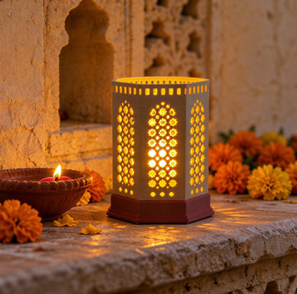 Kumiko Lantern — Jharokha — in a stone alcove with diyas