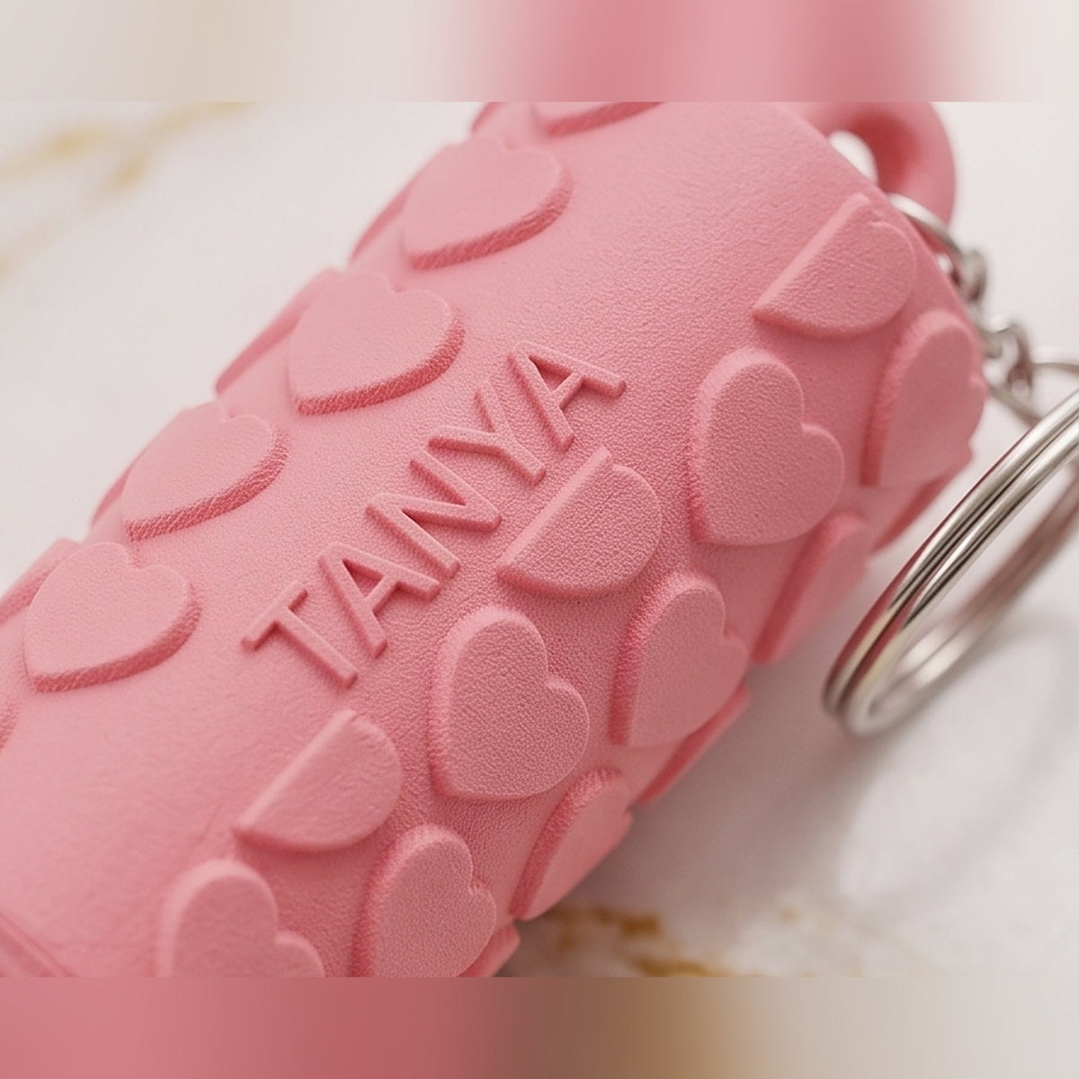 Close-up of the heart design lip balm holder with a name pressed into the pink surface