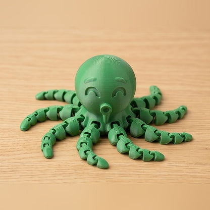 Green articulated octopus toy on a wooden desk, tentacles spread