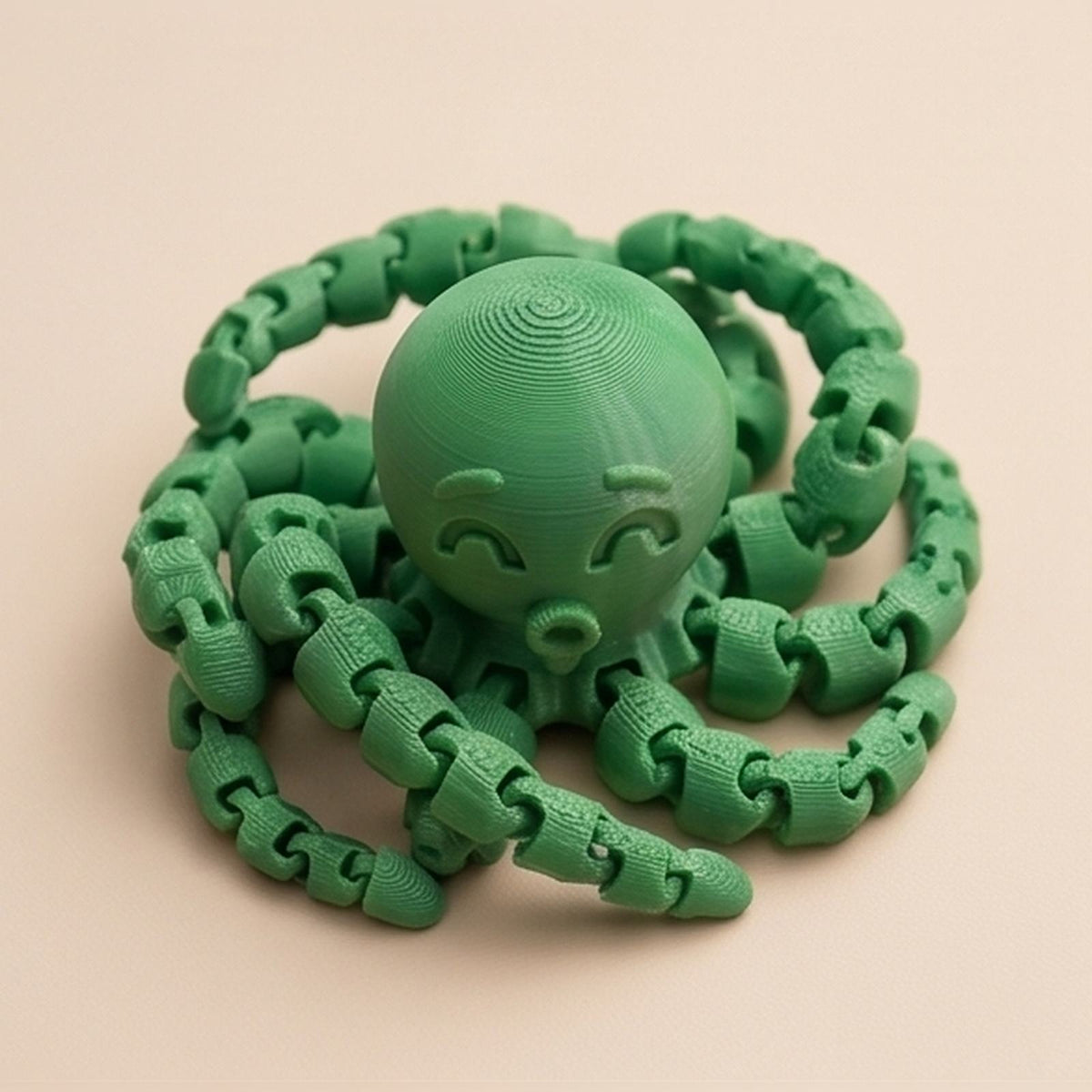 Green articulated octopus seen from above, tentacles curled